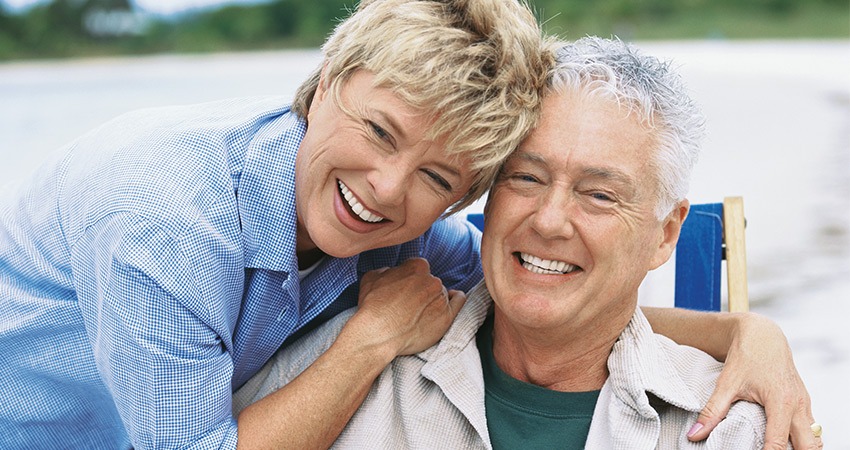 happy middle-aged caucasian couple heads together smiling