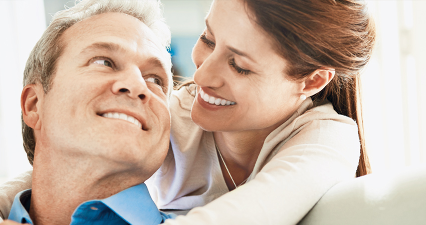 Couple looks into each other's eyes and smiles