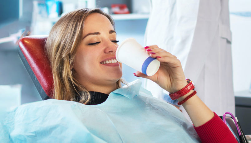 A woman smiles in a dental chair, possibly after IV sedation dentistry in Dresher, PA
