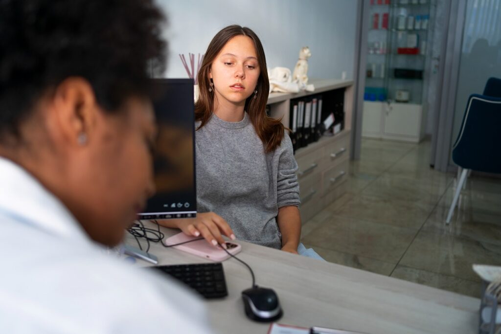 Patient discussing denture options during a dental consultation.
