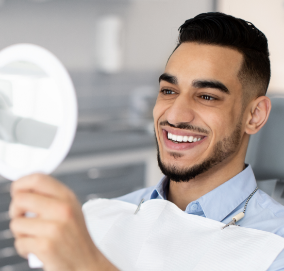 Patient smiling at mirror.