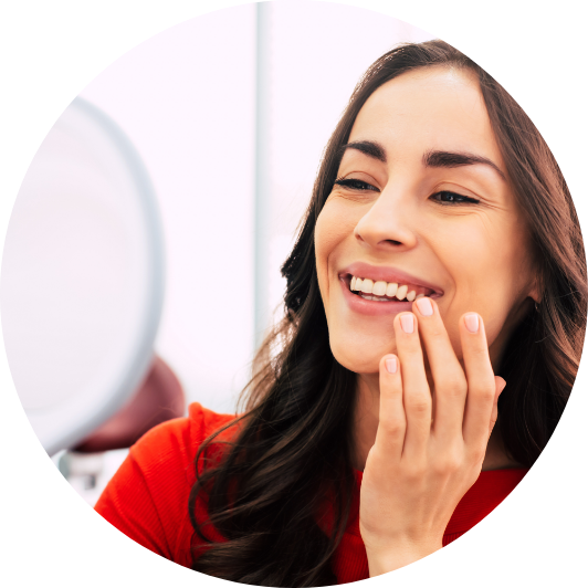 Woman checking her smile in mirror.